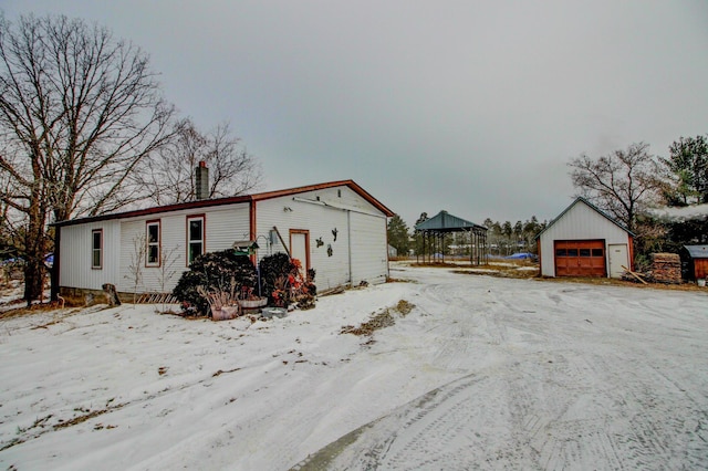 view of front facade with an outbuilding and a garage