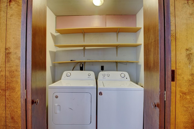 clothes washing area featuring washer and clothes dryer