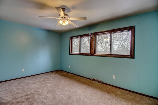 empty room featuring ceiling fan and carpet flooring