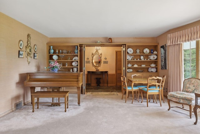 miscellaneous room featuring light colored carpet