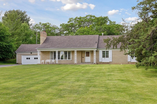 view of front of home featuring a front yard, a porch, and a garage