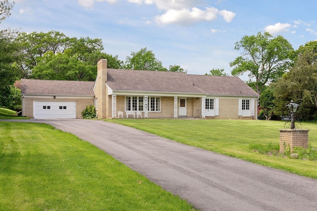 ranch-style house featuring a garage and a front lawn