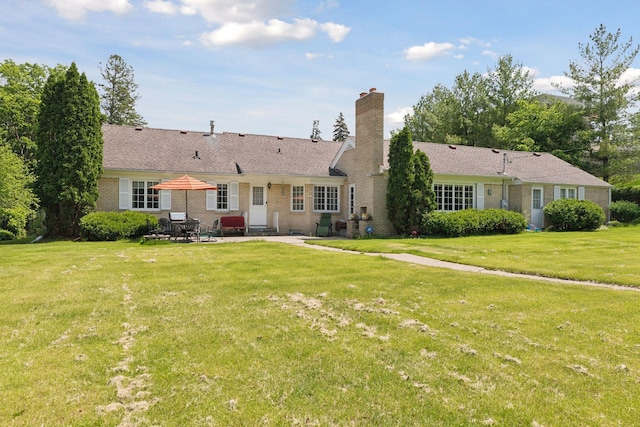 rear view of property with a patio area and a yard