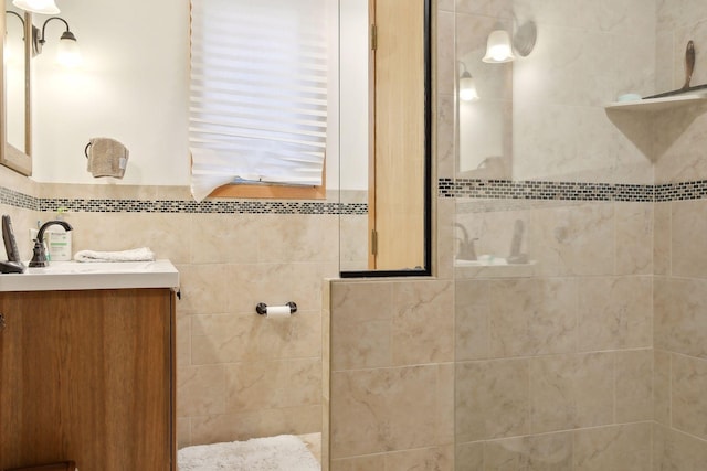 bathroom featuring vanity and tiled shower