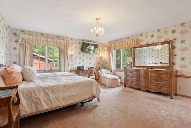 bedroom with a chandelier, light colored carpet, and multiple windows