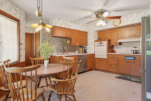 kitchen featuring sink, stainless steel appliances, hanging light fixtures, and ceiling fan