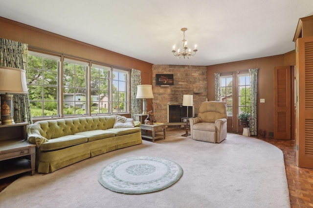 living room with a notable chandelier, parquet floors, a fireplace, and wooden walls