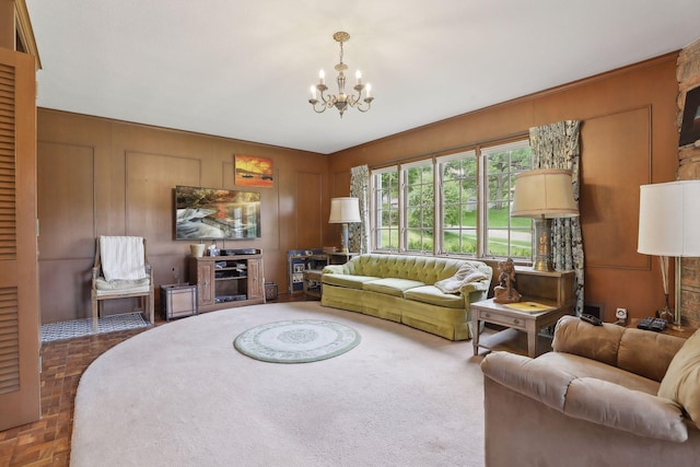 living room featuring parquet flooring and an inviting chandelier