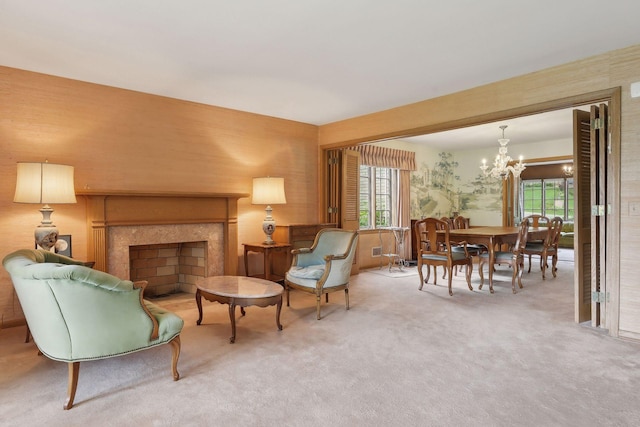 living area with carpet and a chandelier