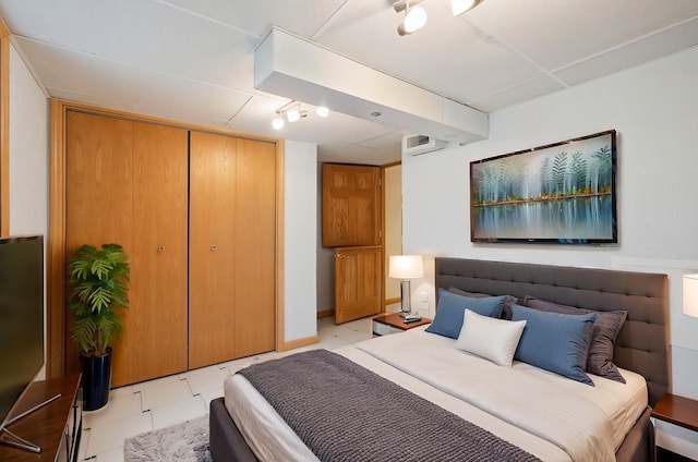 bedroom featuring light tile patterned floors and a closet