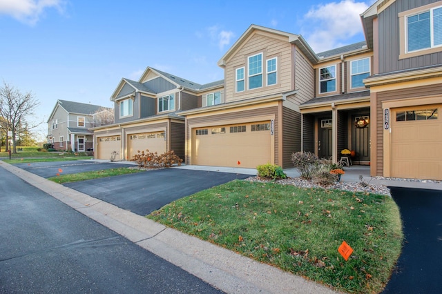 view of front of house with a front yard and a garage