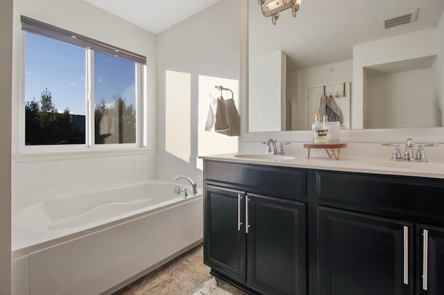 bathroom with vanity and a tub to relax in