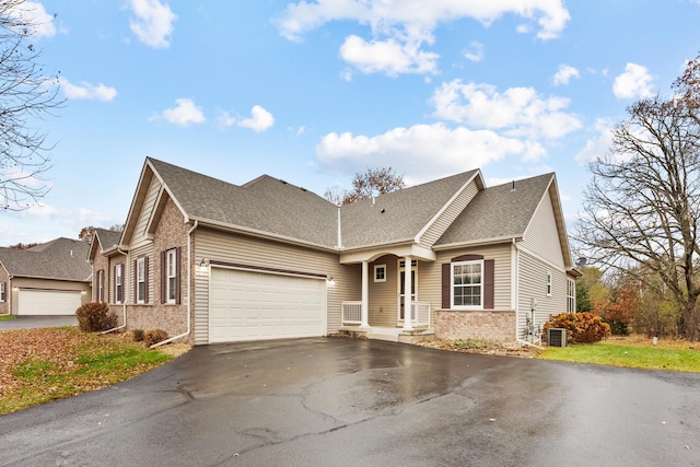 view of front of property with a garage and central AC