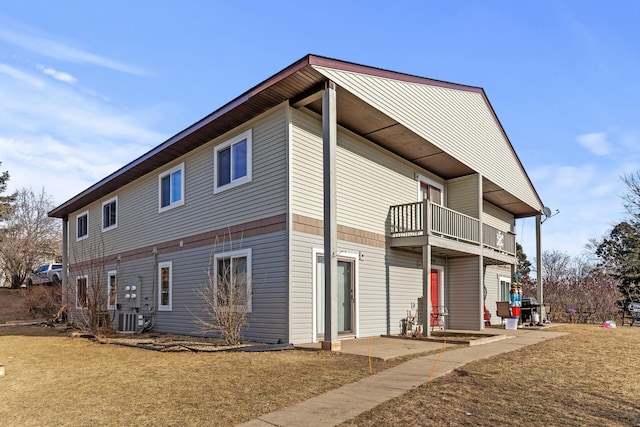 back of property featuring a balcony and central AC unit