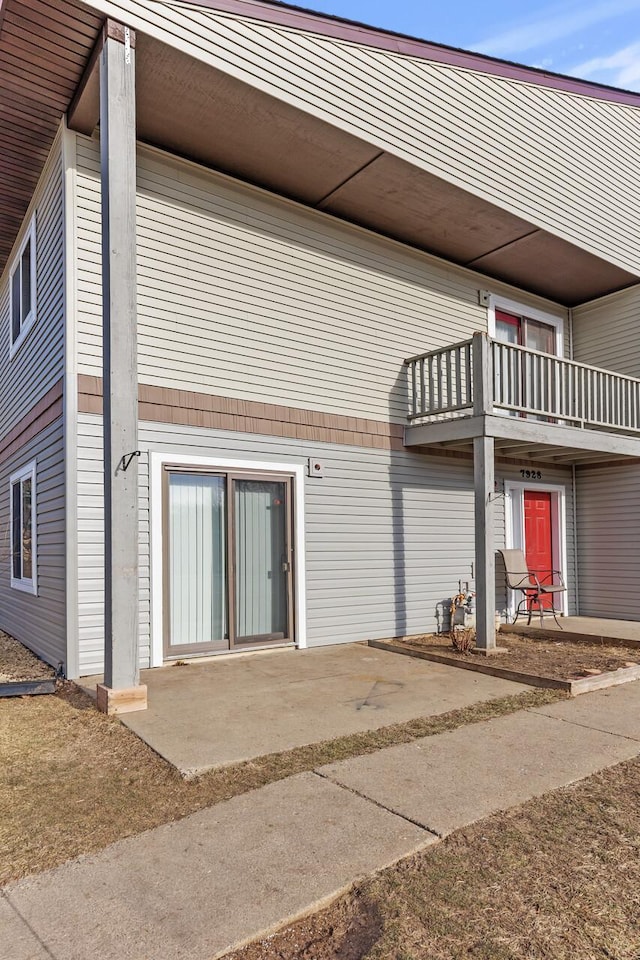 rear view of property featuring a balcony