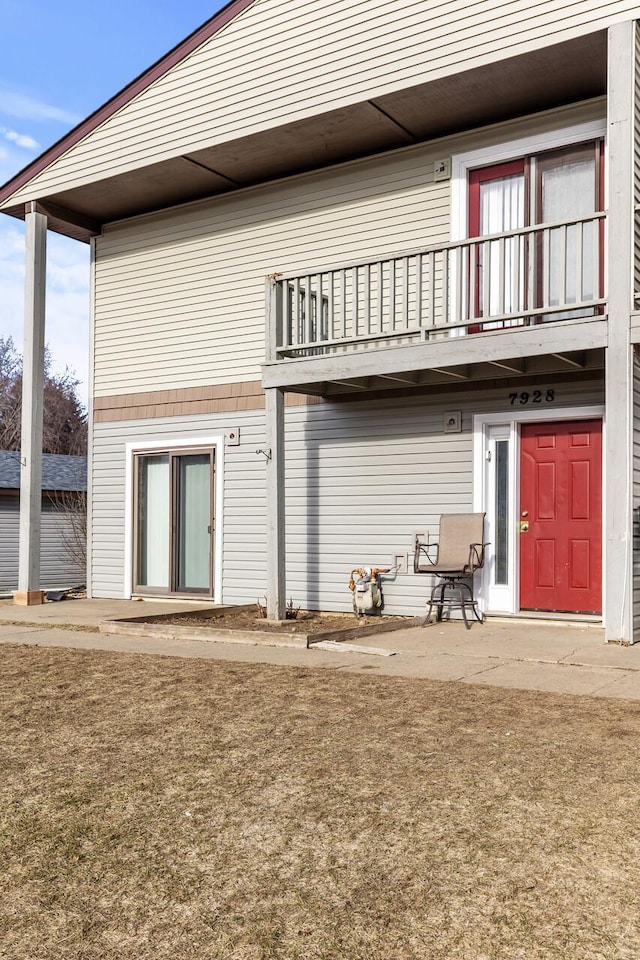 rear view of property featuring a balcony