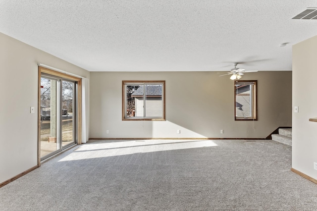 unfurnished room with light carpet, a textured ceiling, and ceiling fan