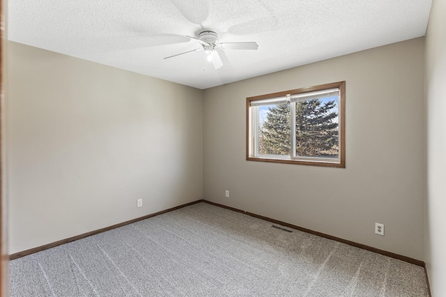 empty room with carpet, a textured ceiling, and ceiling fan