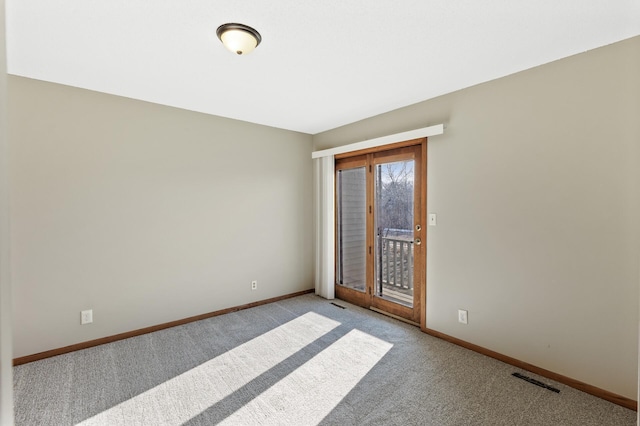 spare room featuring light colored carpet