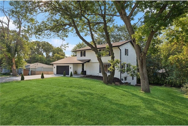 view of front of home with a garage and a front lawn