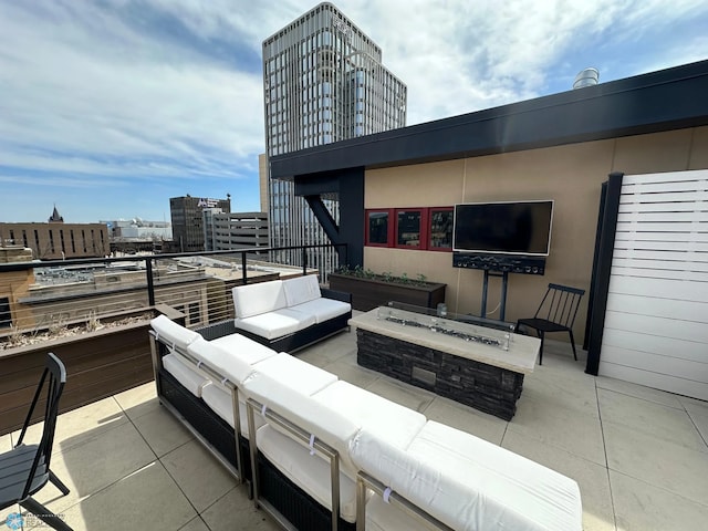 view of patio with an outdoor living space with a fire pit