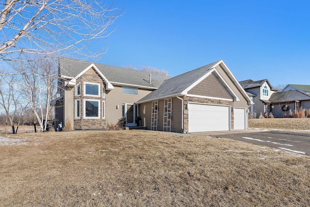 view of front of property featuring a garage and a front lawn