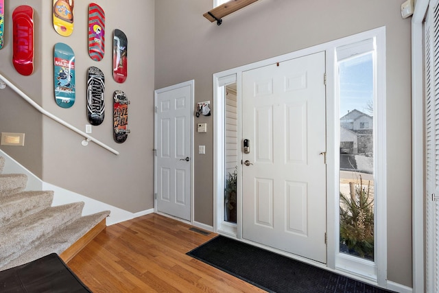 foyer entrance with hardwood / wood-style flooring and a healthy amount of sunlight