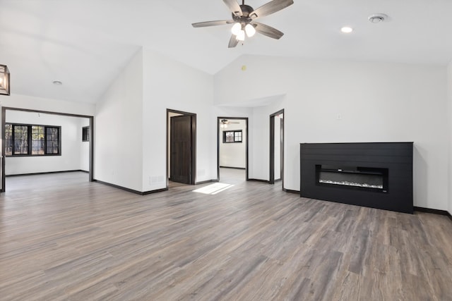 unfurnished living room featuring ceiling fan, high vaulted ceiling, and wood-type flooring