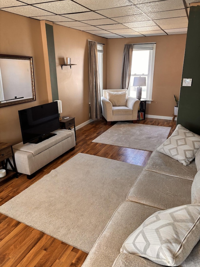 living room featuring hardwood / wood-style flooring and a paneled ceiling