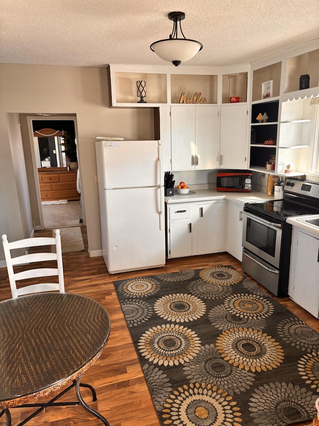 kitchen featuring stainless steel range with electric cooktop, a textured ceiling, white refrigerator, dark hardwood / wood-style flooring, and white cabinets