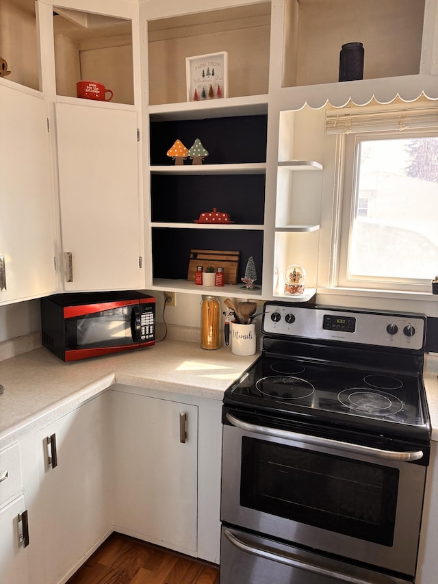 kitchen featuring white cabinets, dark hardwood / wood-style floors, and electric range