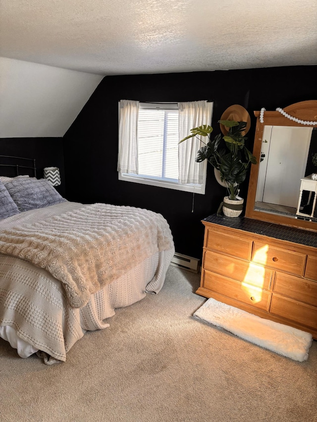 bedroom featuring baseboard heating, lofted ceiling, carpet flooring, and a textured ceiling