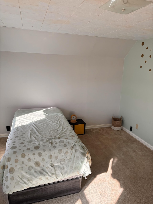 carpeted bedroom featuring baseboards