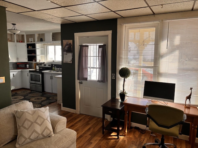 office area featuring dark wood-style floors, a paneled ceiling, and a sink