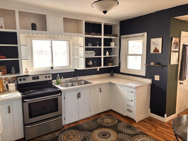 kitchen with a textured ceiling, a sink, stainless steel range with electric cooktop, light countertops, and open shelves