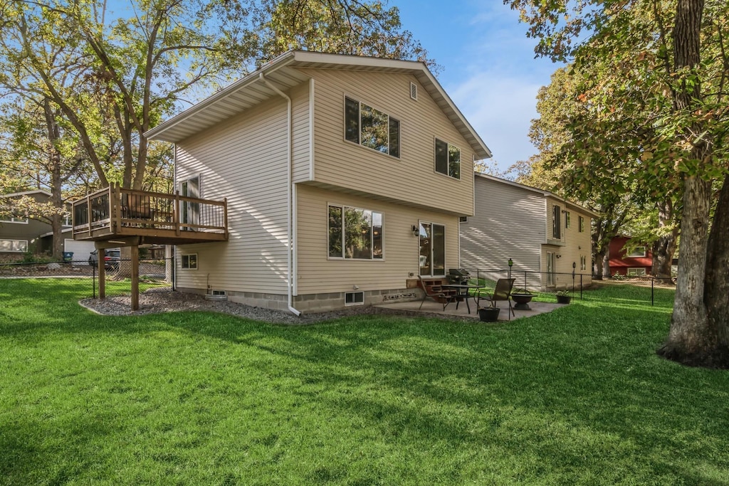 back of house with a lawn, a patio area, and a deck