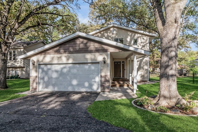 view of front of house with a front yard and a garage