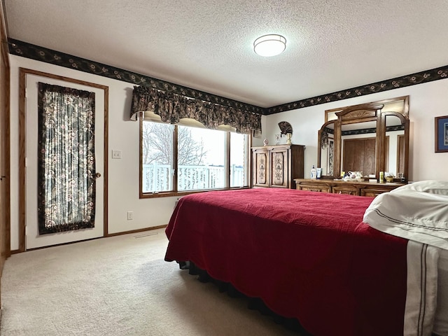 carpeted bedroom featuring a textured ceiling