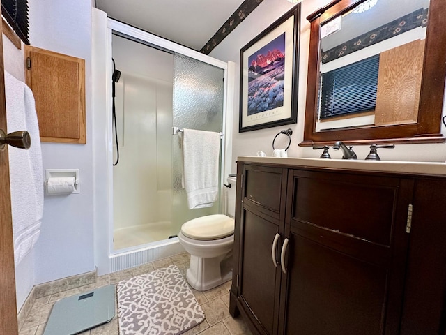 bathroom with tile patterned flooring, vanity, toilet, and walk in shower