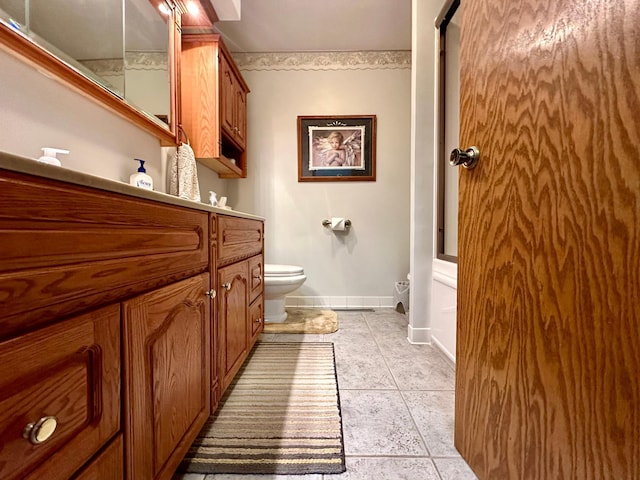 bathroom with tile patterned floors, vanity, and toilet