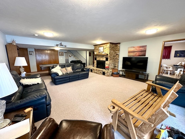 carpeted living room with a fireplace and a textured ceiling