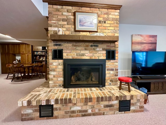 room details featuring carpet flooring and a fireplace