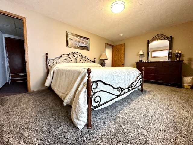 bedroom with carpet floors and a textured ceiling