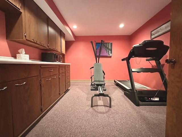 workout room featuring light colored carpet