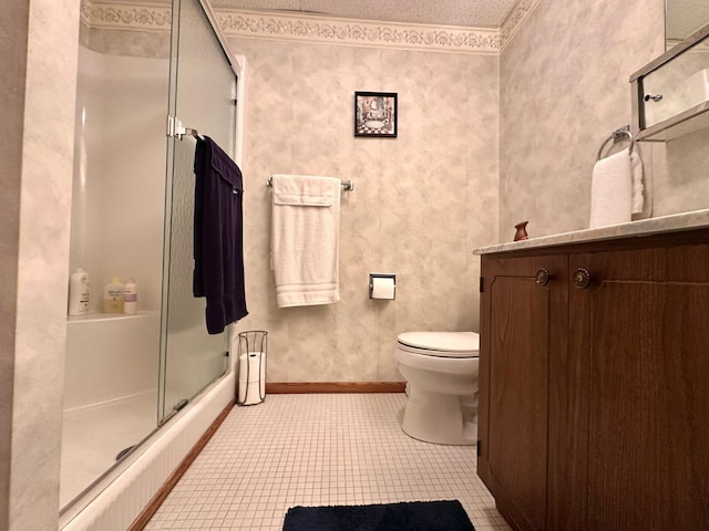 bathroom with tile patterned floors, toilet, an enclosed shower, and vanity