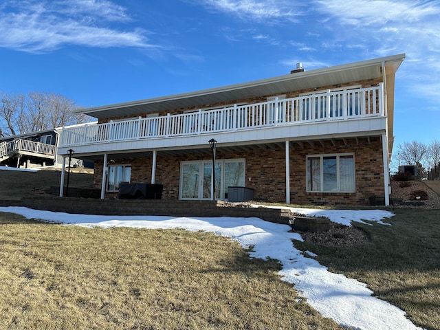 snow covered property featuring a yard and a deck