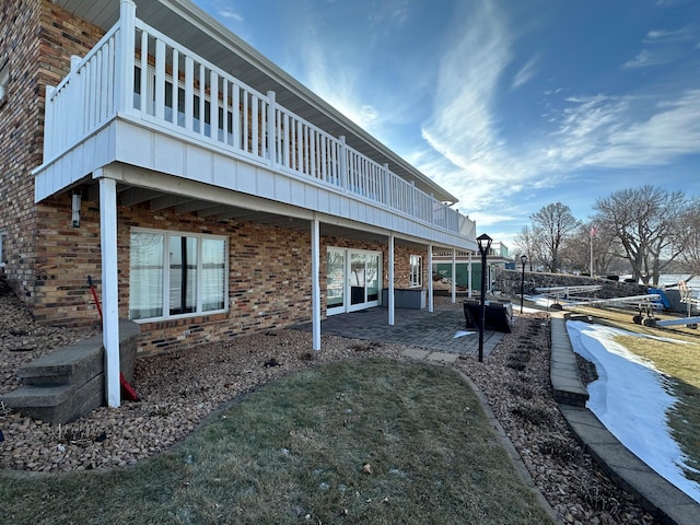 view of side of home with a patio