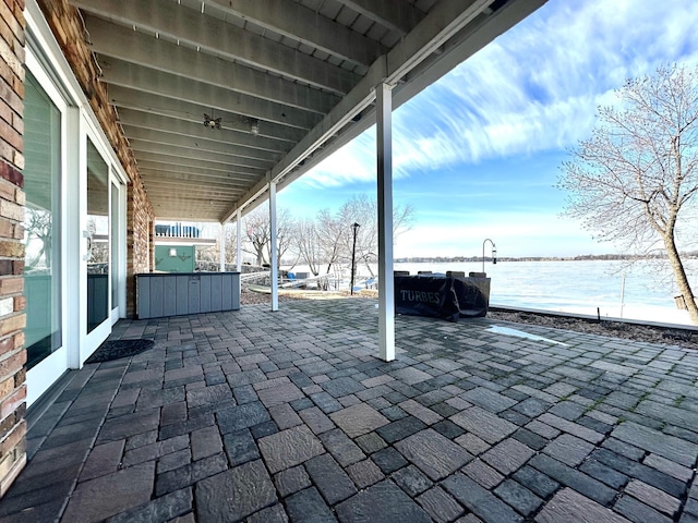 view of patio with a water view