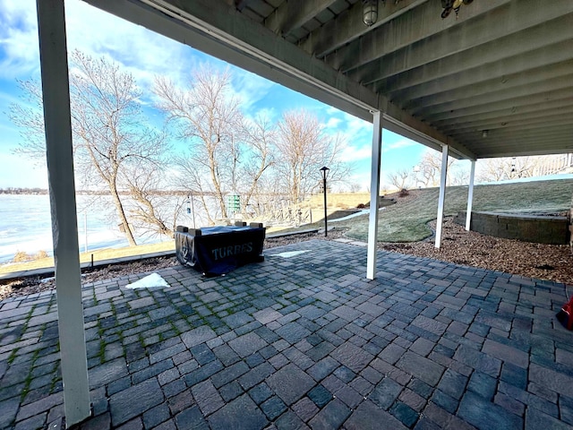 view of patio with a water view