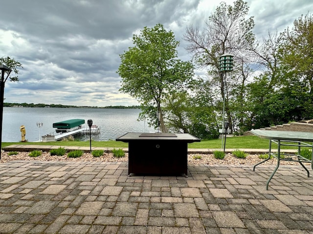 1606 Shore Dr, Worthington, MN 56187 - view of patio / terrace featuring a boat dock, a water view, and a grill